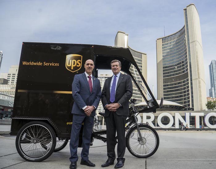 UPS Canada President Christoph Atz, left, and Toronto Mayor John Tory pose with the courier company's new electric assist cargo bike in front of Toronto City Hall on Monday, October 23, 2017. THE CANADIAN PRESS IMAGES/J.P. Moczulski